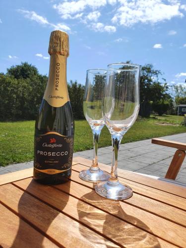 a bottle of champagne and two wine glasses on a table at Byxelkrok, Solis in Byxelkrok