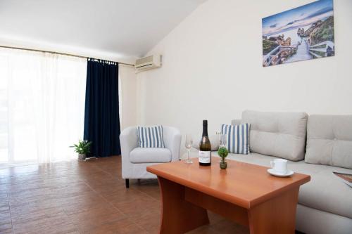 a living room with a white couch and a table at Amon Ra Hotel in Sozopol