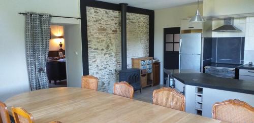 une cuisine avec une table et une cuisine avec une cuisinière dans l'établissement Les Gîtes du Chateau de la Morinière, à Beaupréau