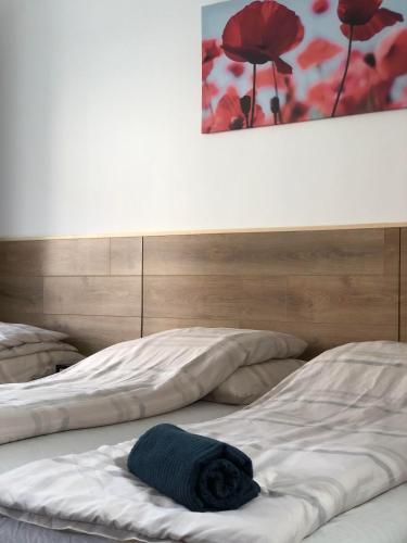 a bed with a blue blanket on top of it at Avas Apartman in Miskolc
