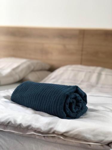 a blue towel sitting on top of a bed at Avas Apartman in Miskolc