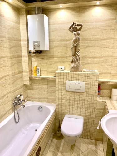 a bathroom with a tub and a toilet and a sink at Cracow. Villa Cherubin Garden in Krakow