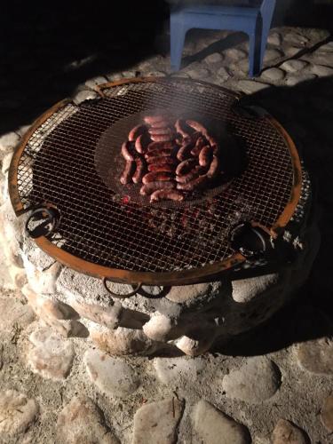a grill with meat cooking on top of it at Casa Gavenniae in Nocciano