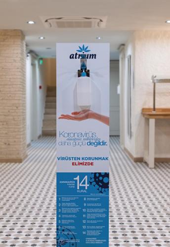 a sign in the hallway of a building at Atrium Taş Otel in Cesme