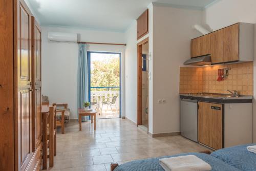 a kitchen and a living room with a table and a kitchen at Anthea Apartments in Palaiochora