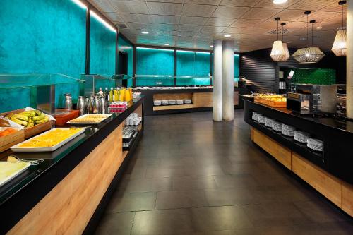 a buffet line in a restaurant with food on display at HG Alto Aragón in Formigal