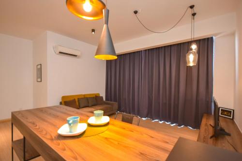 a living room with a wooden table and a couch at Cube 8teens by Nest Home in Johor Bahru