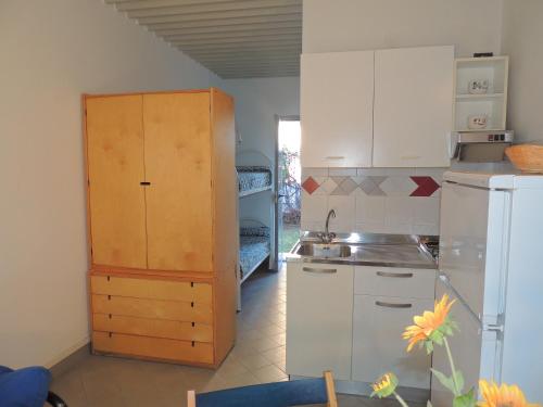 a kitchen with a refrigerator and a counter top at Appartamenti Villaggio Internazionale in Albenga