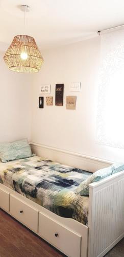 a bed in a white room with a window at Apartamento Lujo Duna Beach in Torrox Costa