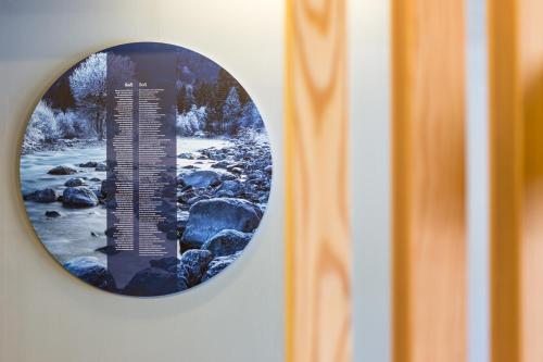 a round window with a picture of a river at Hotel Boka in Bovec