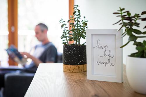 a picture frame sitting on a table next to plants at Hotel Boka in Bovec