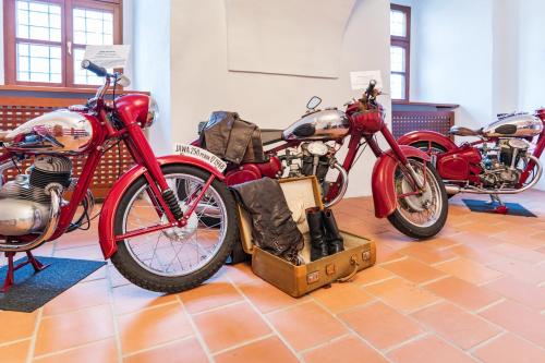 a group of motorcycles on display in a room at Palace Art Hotel Pezinok in Pezinok