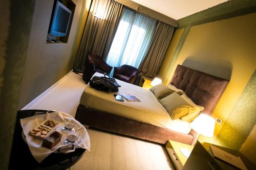 a hotel room with two beds and a table at Castello degli Angeli in Carobbio degli Angeli