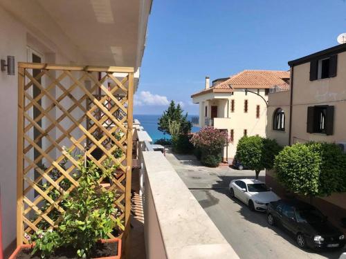 a balcony with a view of a street and the ocean at Bonsai in Tropea