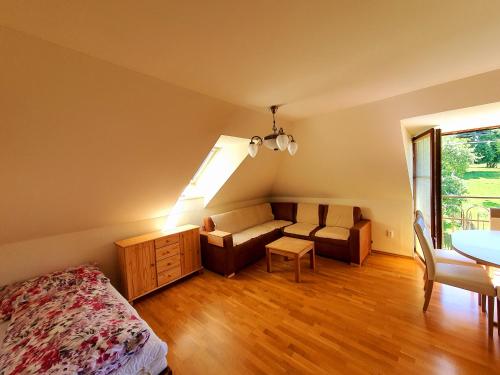 sypialnia z łóżkiem, kanapą i stołem w obiekcie Villa S. Gallen w mieście Liptowskie Matiaszowce