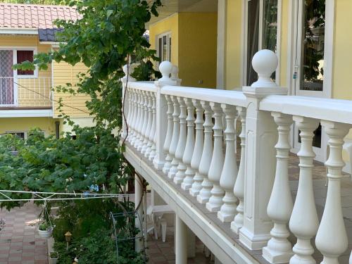 a white railing on a porch of a house at Hotel Lev in Zatoka