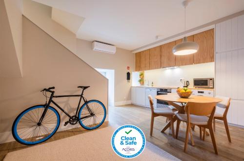 a bike parked next to a table in a kitchen at Matriz Lofts in Ponta Delgada