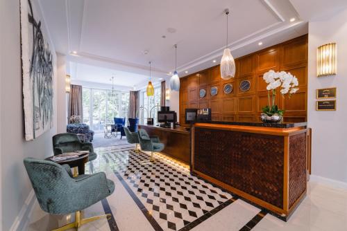 a lobby with a reception desk and chairs at Palace Art Hotel Pezinok in Pezinok