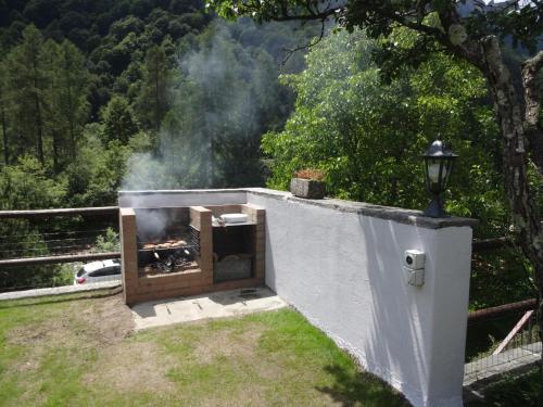 a outdoor oven with smoke coming out of it at Casa Marco in Brione