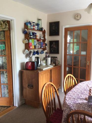 a kitchen with a counter and a table with chairs at Avebury Life in Avebury