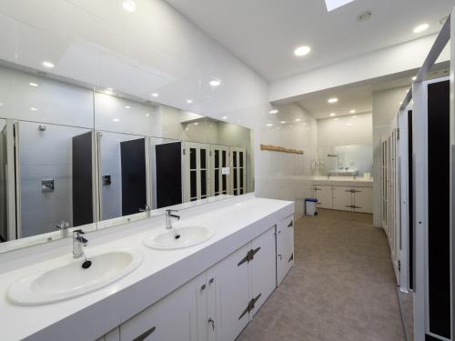 a bathroom with two sinks and a large mirror at El Hostel & CO in Santander