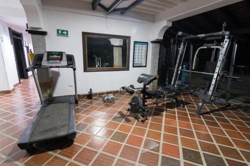 a room with a gym with two tread machines at Finca Hotel La Esperanza in Montenegro