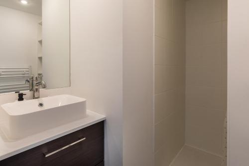 a white bathroom with a sink and a shower at DIFY Desaugiers - Jean Macé in Lyon