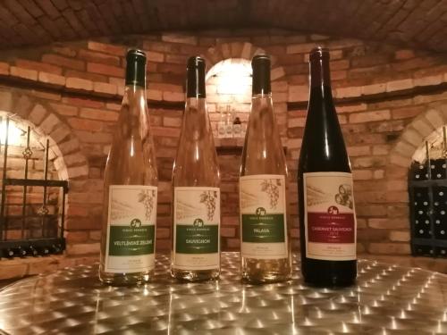 four bottles of wine sitting on a table at Vinný sklep u Malíků in Drnholec