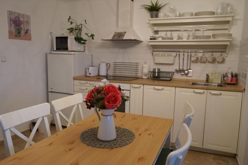 a kitchen with a table with a vase of flowers on it at Studio Boroví in Karlštejn