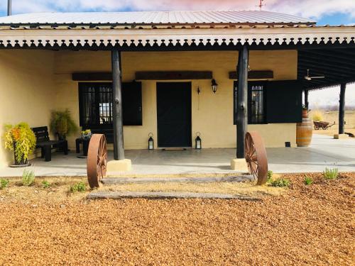 a building with two iron sculptures in front of it at El Madejo - del Valle de Uco in Tunuyán