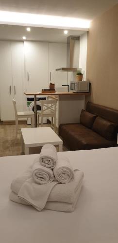 a living room with towels sitting on a table at Alumar Apartamentos Muxia in Muxia