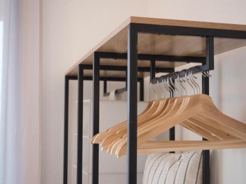 a closet with a rack of wooden hangers at - NEU - LUXUS Frankfurt Flat in Obertshausen