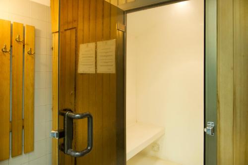 a bathroom with a door with a mirror in it at Abacus Hotel in Sesto San Giovanni