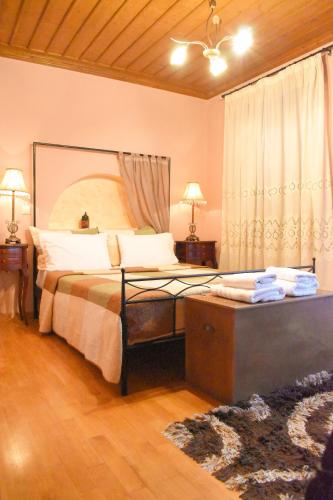 a bedroom with a large bed and a window at Pension Anapli in Nafplio