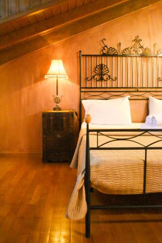 a bedroom with a bed and a lamp in a room at Pension Anapli in Nafplio