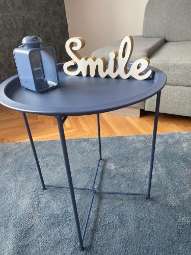 a blue table with a tv on top of it at GabEnd’i Apartman in Eger
