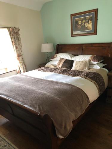Millbrook的住宿－Manor Lodge Guesthouse，卧室配有一张带白色床单和枕头的大床。