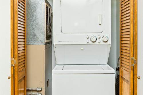 a kitchen with a stove and a refrigerator at Shimmy Shack at 101-A Snowbird in Girdwood