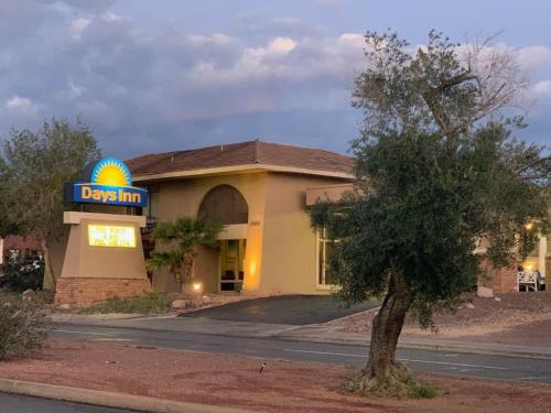 a building with a sign for adq inn at Days Inn by Wyndham Lake Havasu in Lake Havasu City