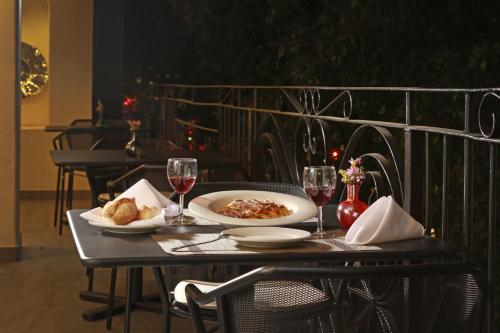 a table with a plate of food and two glasses of wine at Holiday Inn Hotel & Suites Centro Historico by IHG in Guadalajara