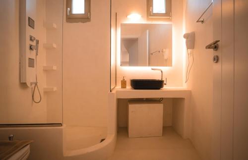 a bathroom with a sink and a mirror and a shower at ZOE in Apollonia