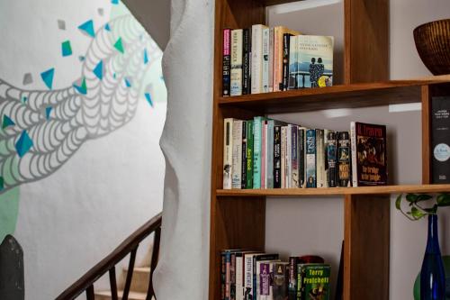 
a bookshelf filled with books and bookshelves at La Palmita Budget Boutique Hotel in Tulum
