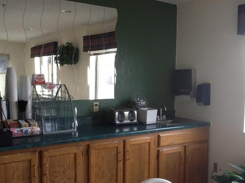 a kitchen with a counter with a counter top with a counter top at Super 8 by Wyndham Kennett in Kennett