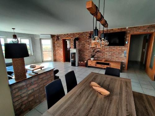 Il comprend une cuisine et une salle à manger avec une table et des chaises en bois. dans l'établissement Loft Unterkunft in Hügelsheim, à Hügelsheim