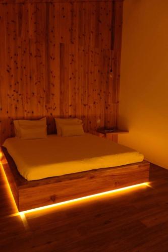 a bedroom with a bed with lights on it at Estúdio Azul in Ponta Delgada