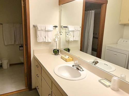 a bathroom with a sink and a mirror at Jackson Hole Vacation Condominiums, a VRI resort in Wilson