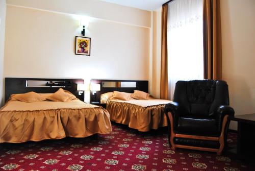 Un pat sau paturi într-o cameră la Hotel Magic GT Trivale