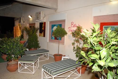 a room with three lounge chairs and potted plants at B&B Panoramic in Valguarnera Caropepe