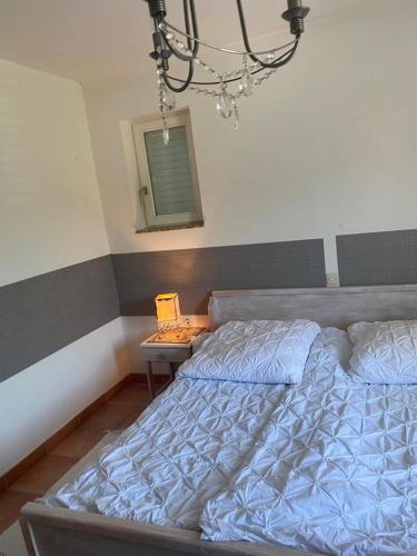 a bedroom with a bed and a table with a mirror at Casa Fumica Apartment in Palit