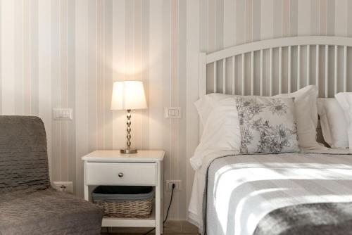 a bedroom with a bed and a lamp and a chair at Podere n°8 Agriturismo in Maremma in Alberese